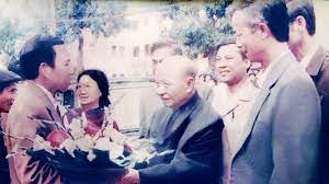 Thầy Nguyễn Văn Xuyên tặng hoa chúc mừng Tổng bí thư Trường Chinh về thăm trường THPT chuyên Lê Hồng Phong năm 1987. Ảnh: TL