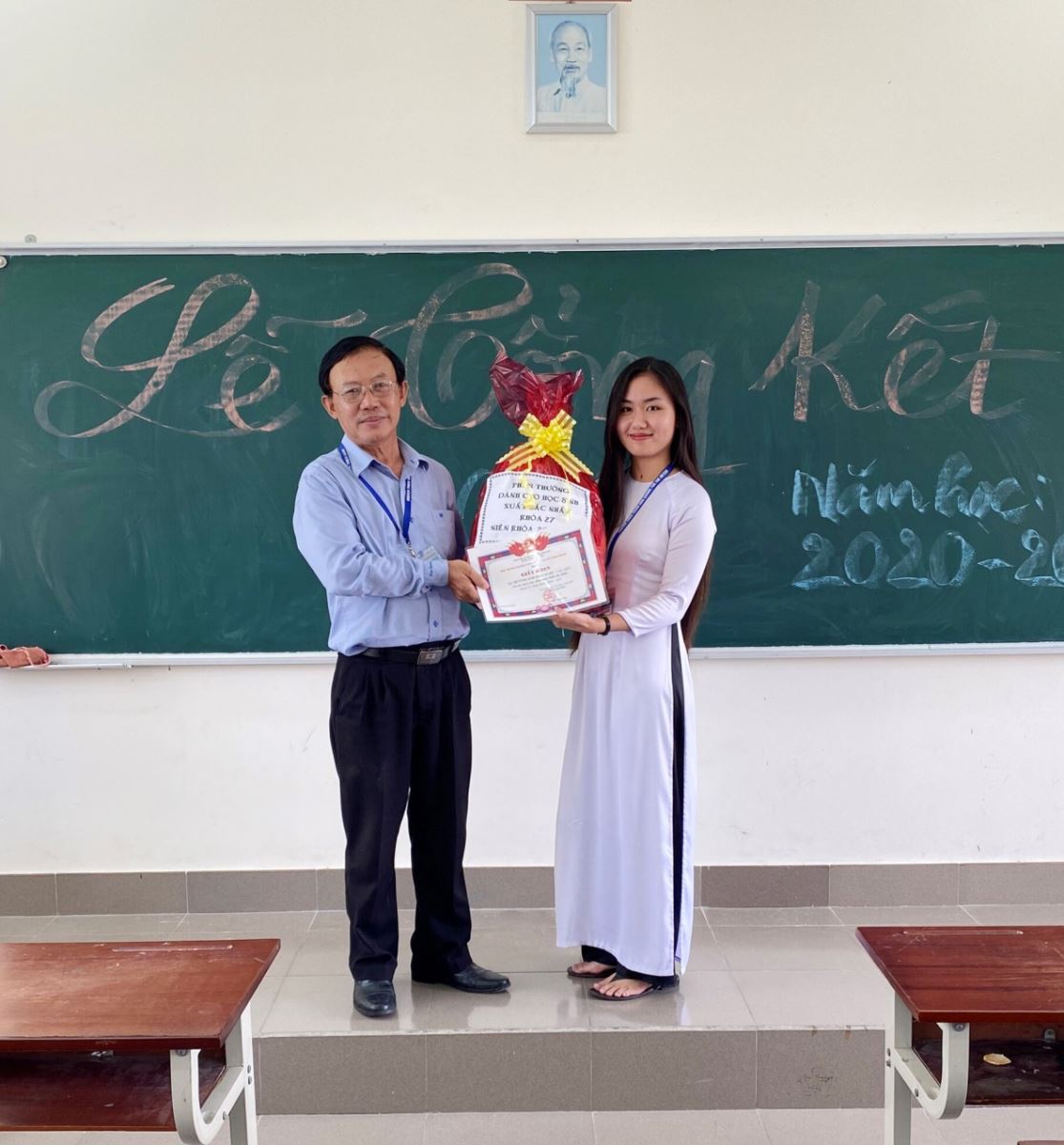 Ban Giám hiệu trường trao giấy khen đạt thành tích xuất sắc toàn khóa năm học 2020 – 2021 cho em Bảo Ngọc. Ảnh: CTV